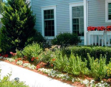 Exterior Front. Flowers, flowers and...