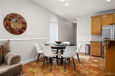 Dining space with light tile patterned floors