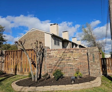 View of side of home with a chimney, fence, and br