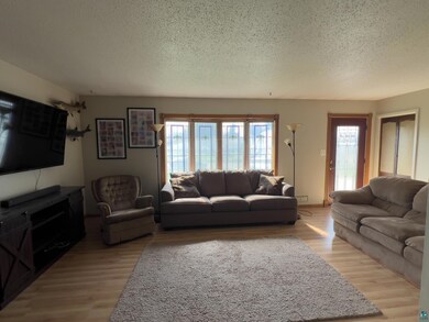 Living room with hardwood / wood-style flooring an