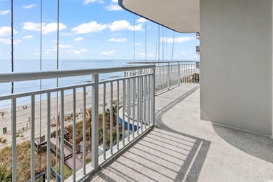 Balcony with a water view and a view of the beach