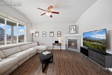 Living room featuring lofted ceiling, gas fireplac
