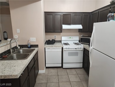 Kitchen featuring white appliances, under cabinet