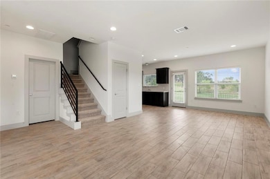 Unfurnished living room featuring light wood-styl