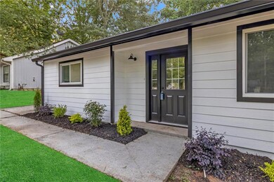 View of exterior entry featuring a lawn