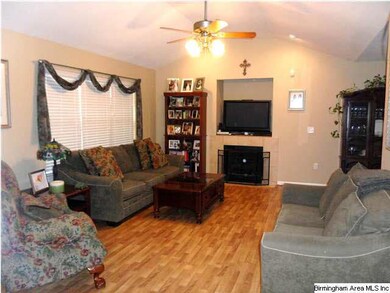 Open and inviting living space has vaulted ceiling