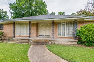 Ranch-style house with a front lawn and covered po