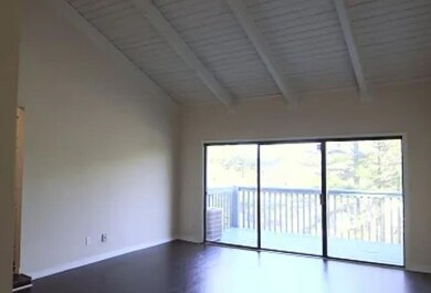 Spare room with beamed ceiling, high vaulted ceiling, and baseboards
