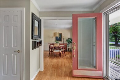 Foyer with wood floor and coat closet. Opens to th
