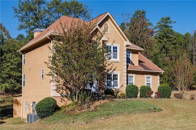 Traditional-style house with a front yard, stucco siding, and a chimney