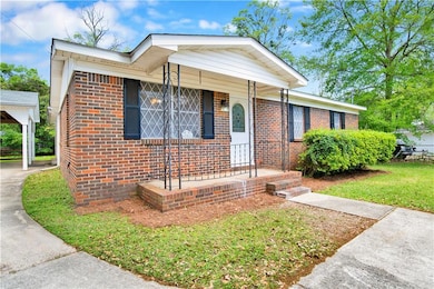 View of front of home featuring driveway and brick