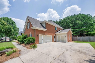View of home's exterior featuring brick siding, concrete driveway, roof with shingles, and an attached garage