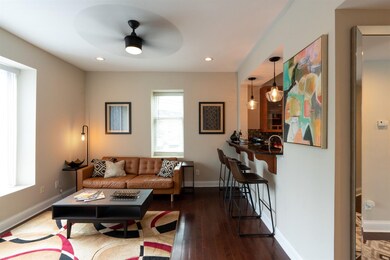 Living room includes a Juliet balcony for warm bre