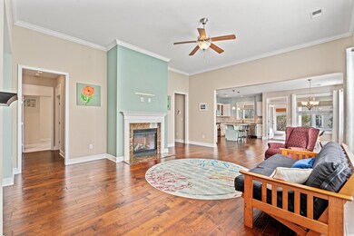 Living room featuring a fireplace, dark hardwood /