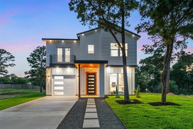 Modern home with a balcony, concrete driveway, bo