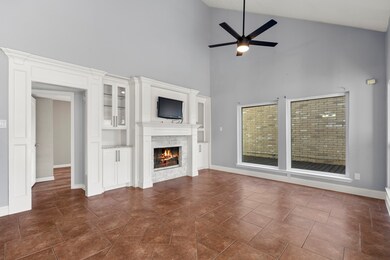 Cozy living room showcasing a traditional stacked-stone fireplace with built-in cabinetry for added storage and display—perfect for both comfort and functionality.