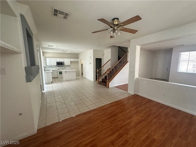 Unfurnished living room with stairway, light wood-
