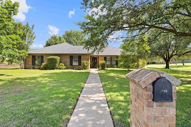 Ranch-style home with brick siding, roof with shin