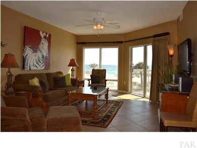 Living area is beautifully appointed, perfect for relaxing beach setting. Colors are neutral with bright accents