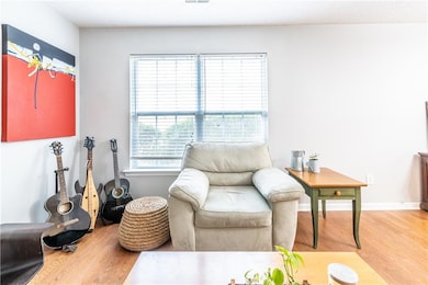 Sitting room featuring baseboards, wood finished f