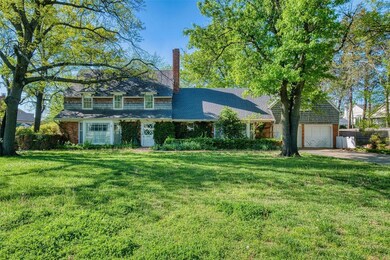 View of front of house with a garage and a front y