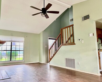 Unfurnished living room featuring high vaulted cei