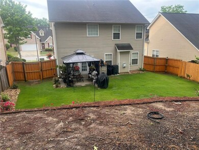 Back of house featuring a patio, a fenced backyard, a gazebo, and a gate