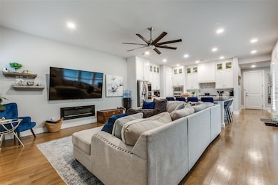 Living room featuring ceiling fan and light hardwo
