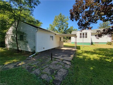 Rear view of property featuring a lawn