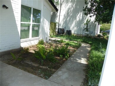 View of side of home with a central AC unit