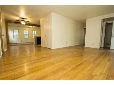 Notice the open living space and hardwood floors t