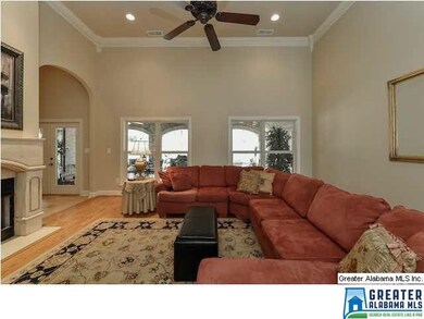 The huge living room has a feature fireplace, rece