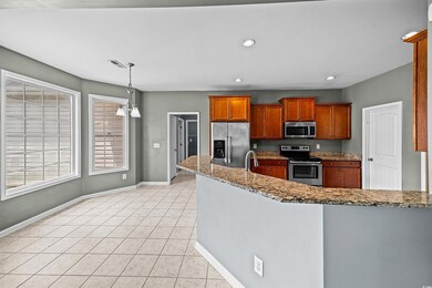 Kitchen with light tile patterned floors, applianc