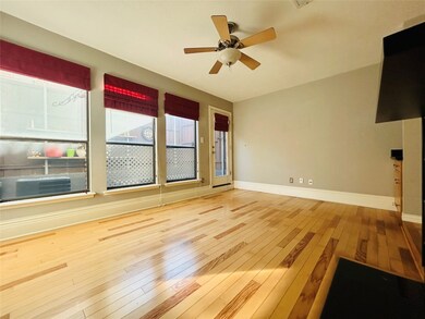 Unfurnished living room featuring light wood-style floors and ceiling fan