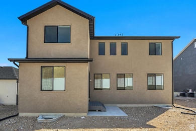 Rear view of property featuring a patio and stucco siding