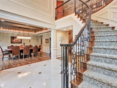 Grand Foyer with curved stairs ~ second rear stairs off kitchen