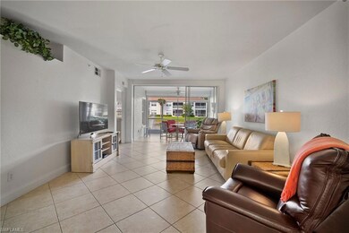 Living room with ceiling fan and light tile patter