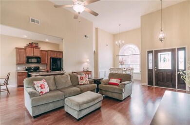 Welcoming Entry with Leaded Glass Wood Door,   Side lights, Hardwood Floor and Chandelier