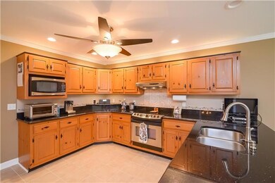 The spacious kitchen has tiled flooring, granite, recessed lighting, pantry and all appliances to remain!