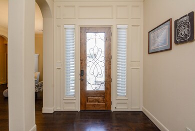 Elegant entry with crown molding and solid wood floors through the main living areas.