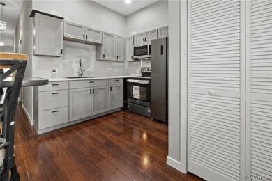 Kitchen featuring gray cabinetry, stainless steel
