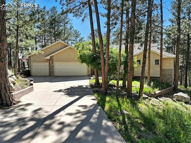 Mid-century home with stone siding, stucco siding, concrete driveway, and a garage