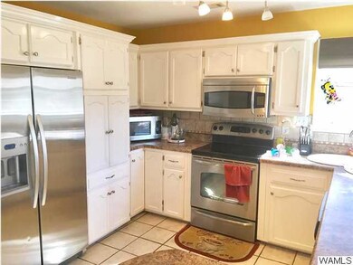 Kitchen has ceramic tile flooring