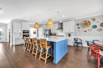 Kitchen with a spacious island, dark wood-style fl