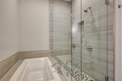 Bathroom featuring a shower stall and a garden tub