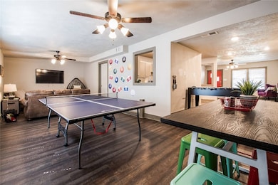 Recreation room with visible vents, wood finished