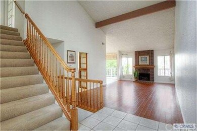 Spacious living room with fireplaces and wood floo