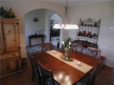 Formal Dining Room With Hardwood Floors & Arched D