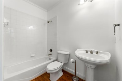 Bathroom with baseboards, ornamental molding, show