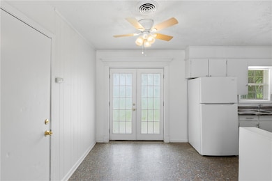 Entryway with french doors, a sink, ornamental mol